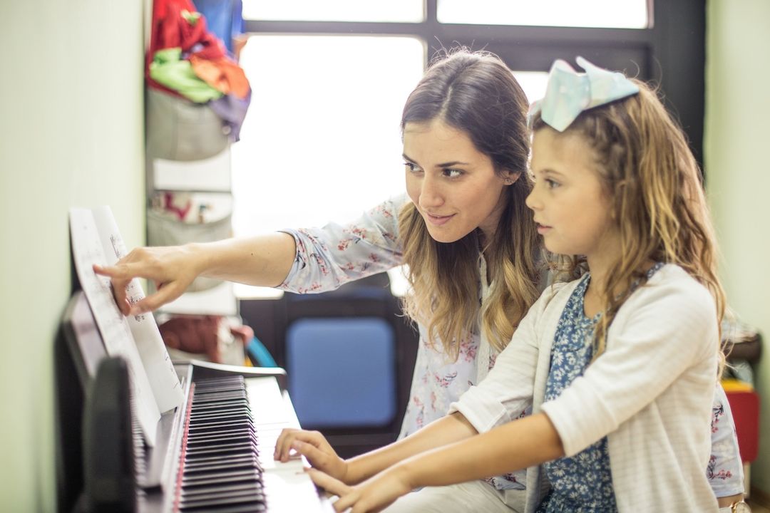 A student in a private piano lesson